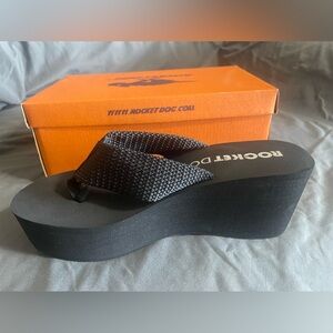 BRAND NEW. Never worn. Rocket Dog platform flip flops. Woman’s size 11.